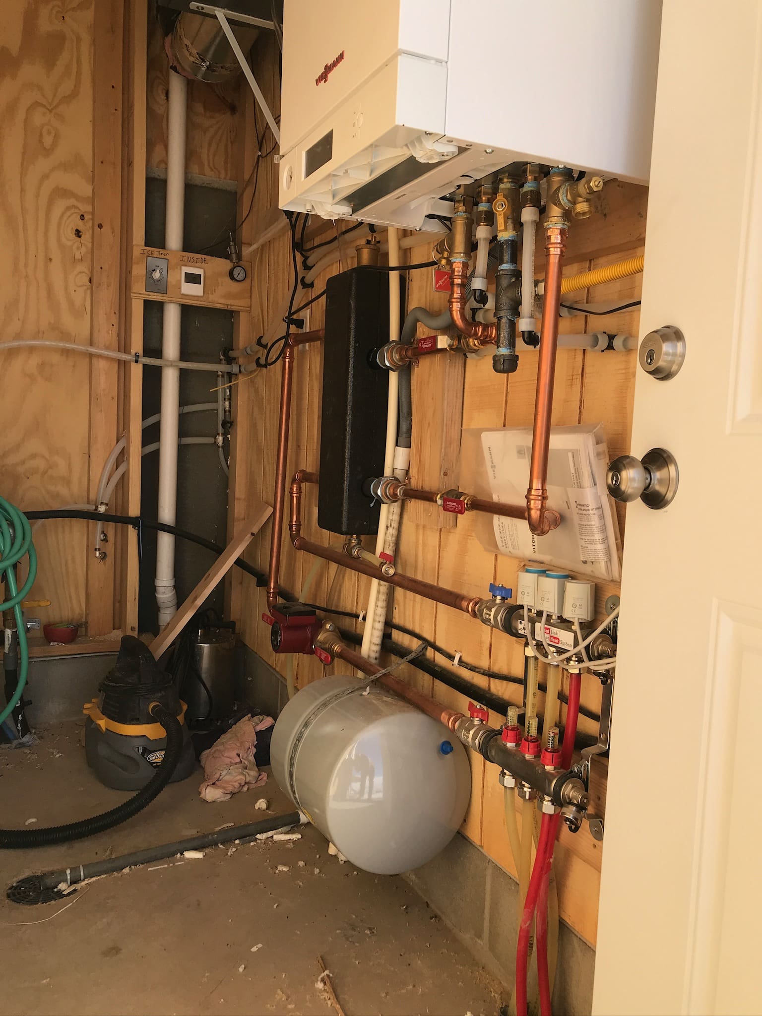 A view of the inside of a house with pipes and wires.