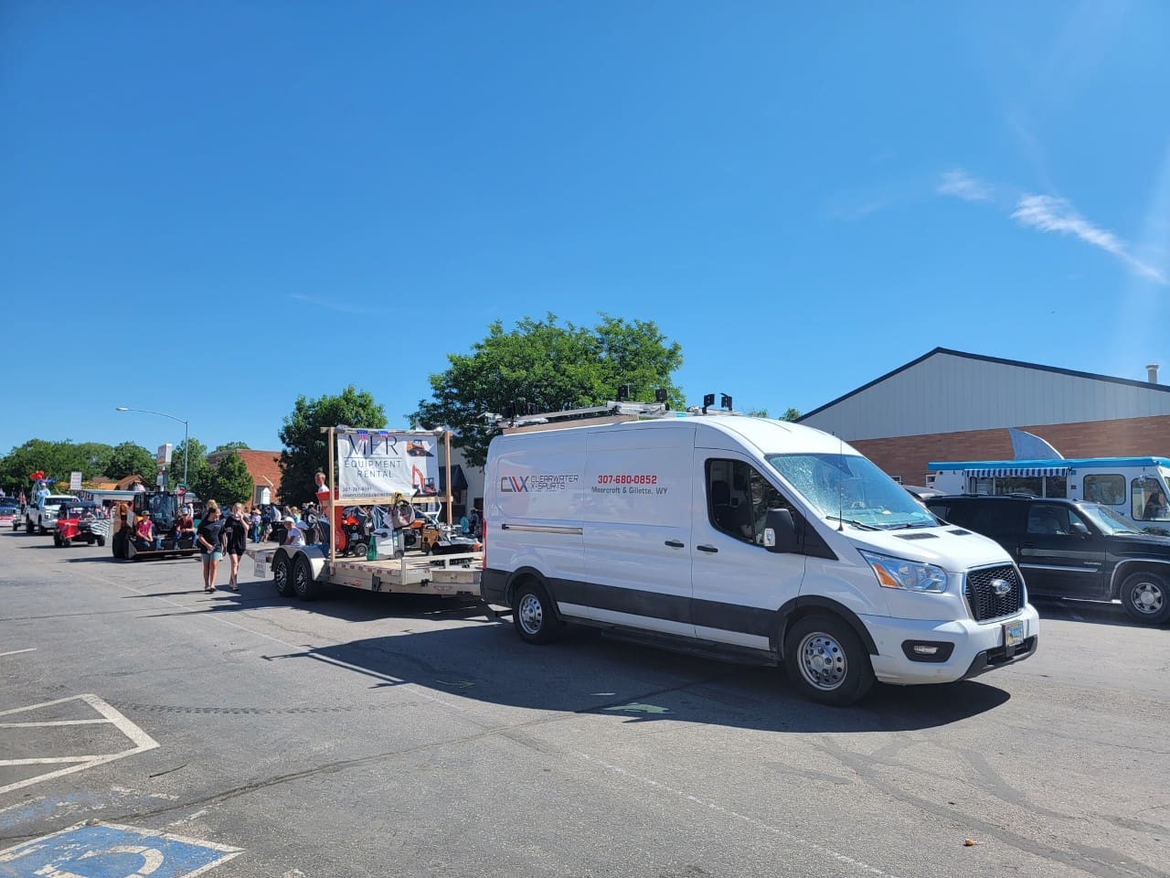 A white van is parked in the parking lot